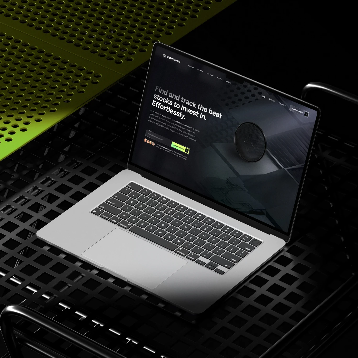 Superstocks landing page on a laptop resting on a black metal surface